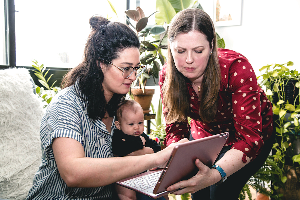 Annie Frisbie with Client, Baby, and Tablet Computer
